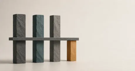 Four stone pillars of unequal height; a level slab rests on the shortest one while the three taller pillars rise unused above it